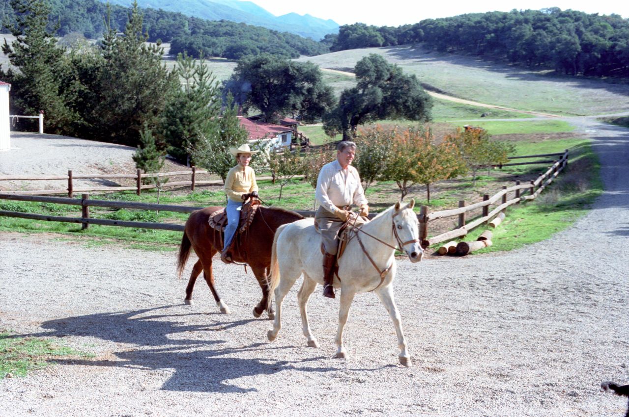 President Ronald Reagan and first lady Nancy Reagan ride horses at their vacation home in Santa Barbara, California, in November 1982.