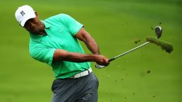 Tiger Woods takes a big divot as he plays his approach shot to the second hole at Oak Hill Country Club. 