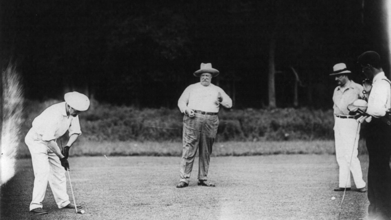 President William H. Taft, center, enjoys a round of golf at the Chevy Chase Country Club in Maryland in 1909. 