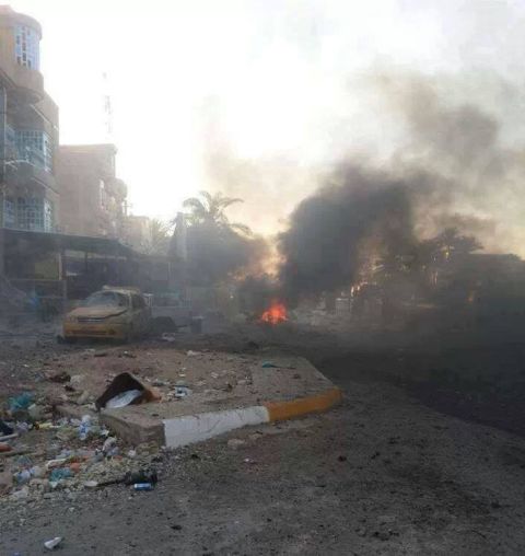 Smoke rises from the scene of a car bomb attack in the Baghdad suburb of Kadhimiya on August 10.
