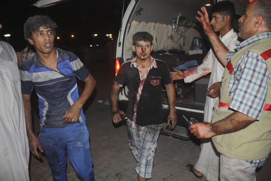 Victims of a car bomb attack in Nasiriyah City, south of Baghdad, emerge from the scene of an attack on Saturday, August 10.