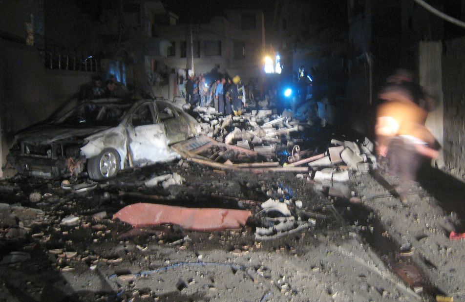 First responders inspect the scene of a car bomb attack near a mosque in Kirkuk on August 10.