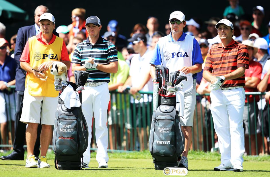 Rory McIlroy, second from left, and Francesco Molinari, far right, await their turn in the third round. McIlroy, the defending champion, trails Furyk by six shots.  