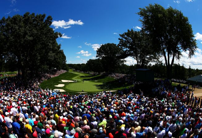 Fans look on at the 13th hole as Phil Mickelson putts. The round wasn't lucky for Mickelson, as the British Open champion shot a 78.