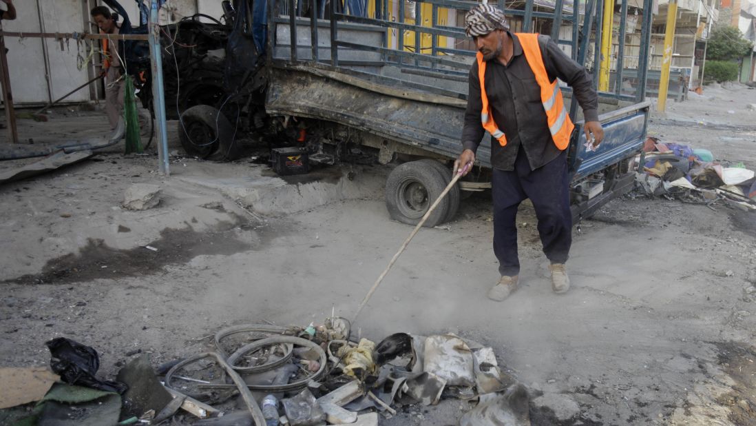 A man cleans up debris in Baghdad on August 11.