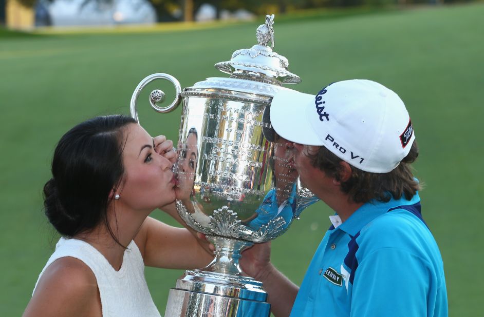 Dufner hugged wife Amanda after clinching victory and the two soon got up close and personal with the winners' trophy. 