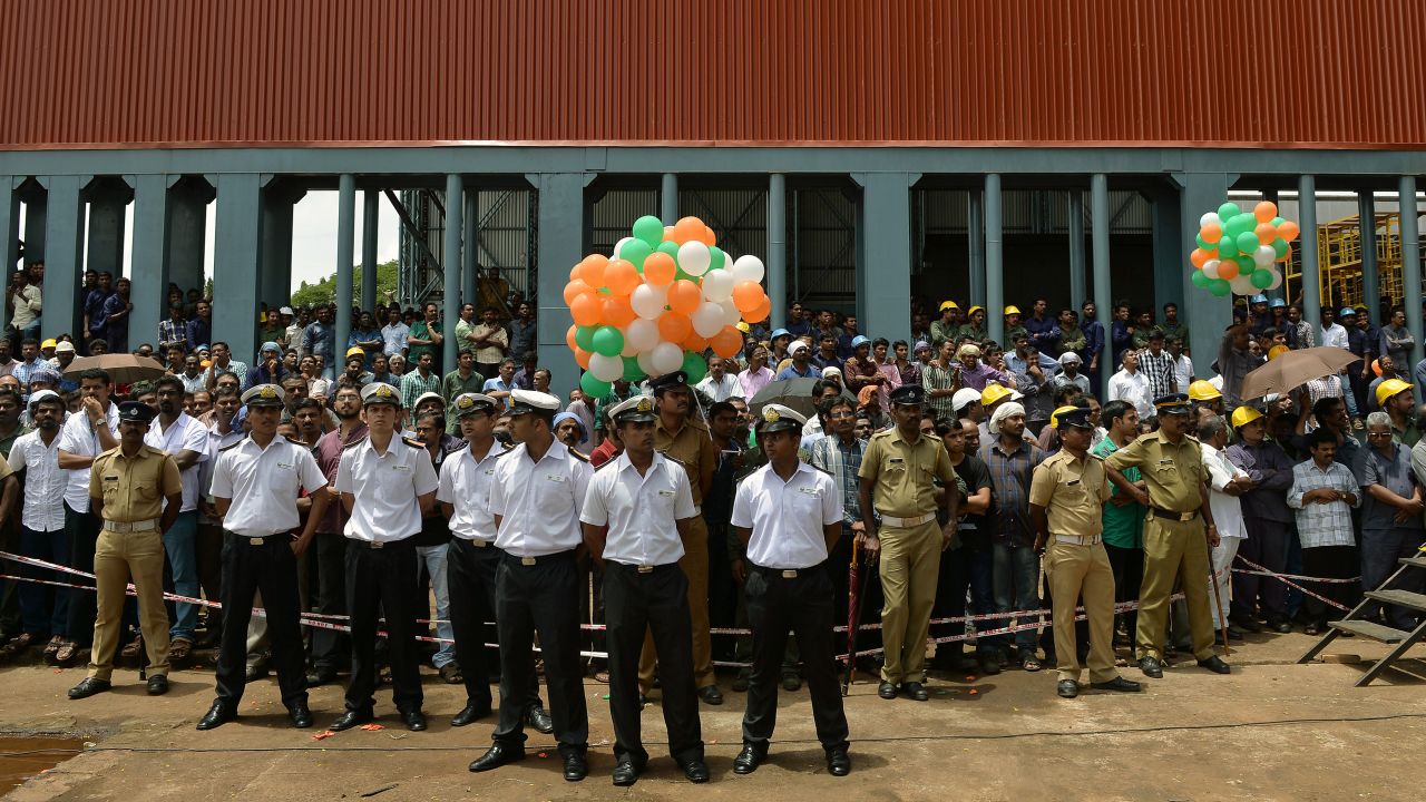 Naval officers stand during the launch of the ship at the Cochin Shipyard on August 11.
