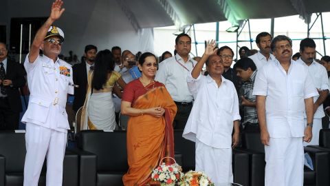 Indian Defense Minister AK Antony, second right, his wife, Elizabeth, and other officials wave after the launch of the aircraft carrier on August 12.