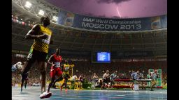 Jamaica's Usain Bolt wins the 100-meter final at the 2013 IAAF World Championships on August 11 as lightning flashes across the Moscow skies. 