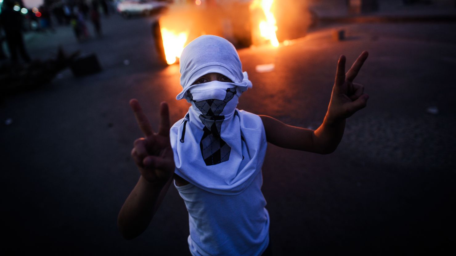 A Bahraini boy flashes the v-sign during the funeral of 10-year-old Ali Jaffer Habib, in the village of Malikiya, on August 10, 2013.