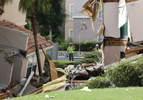 Inspectors look over damage to buildings on Monday, August 12.