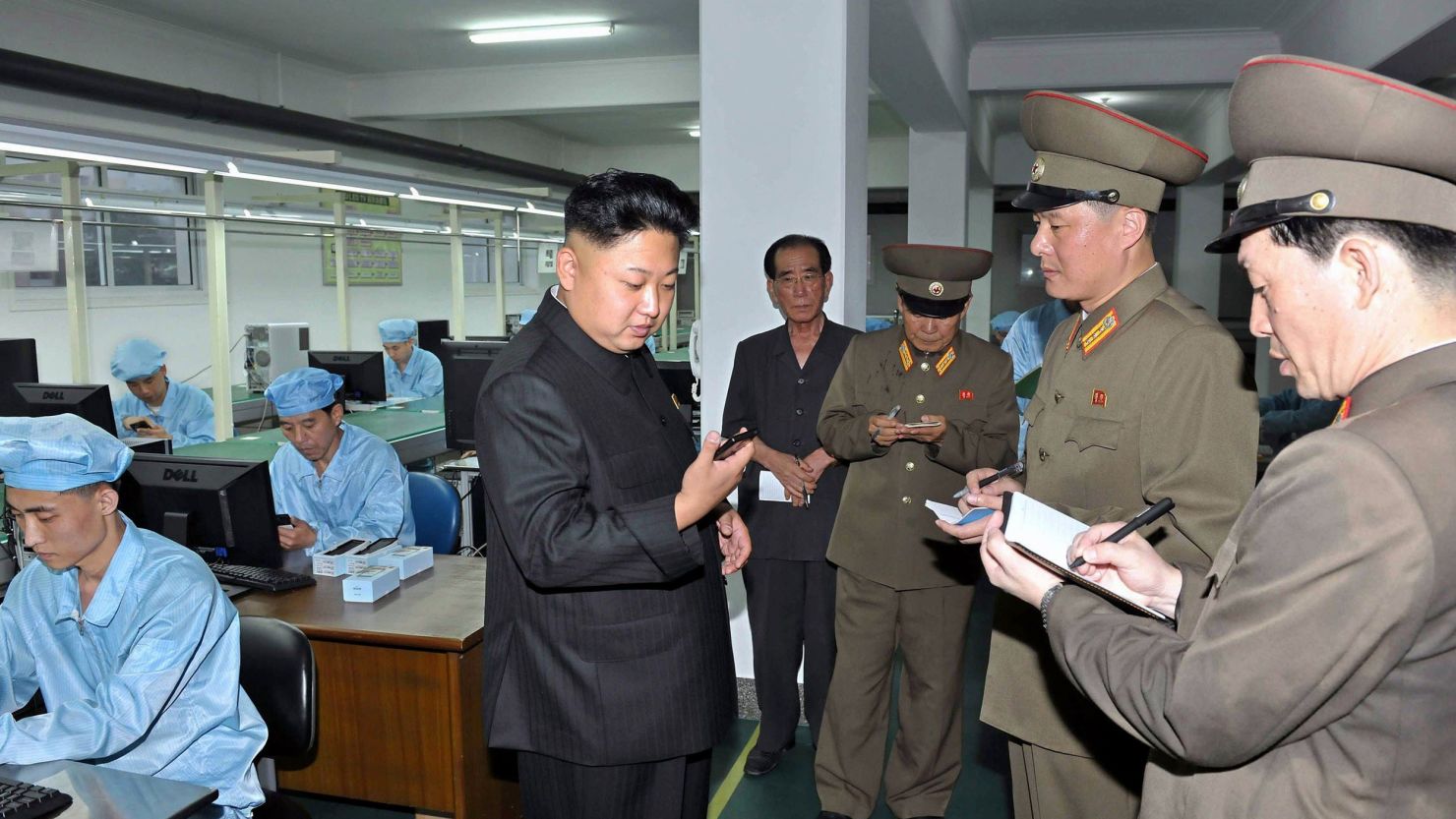 North Korean leader Kim Jong-Un inspects production of new touch-screen mobile phones.
