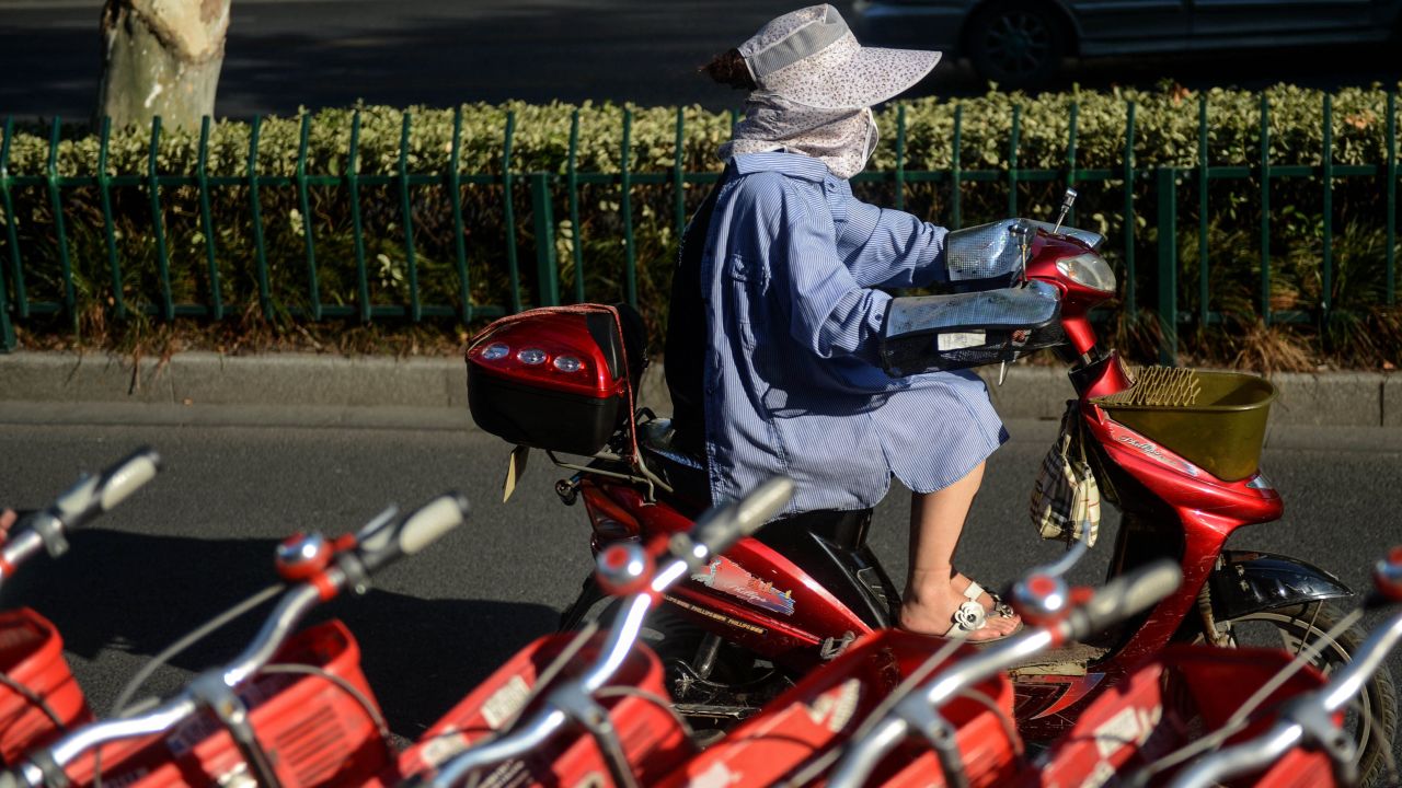 A woman wears sun-protective clothing as she rides in Hangzhou, China, on Monday, August 12. <a href="http://www.cnn.com/2013/08/13/world/asia/asia-heat/index.html">Temperatures have spiked in Northeast Asia</a> this summer, causing heat-related deaths as well harming crops and livestock.