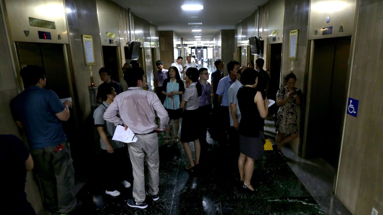 People wait for working elevators at a government building in Seoul, South Korea, on August 12. The hot weather has put a strain on South Korea's power grid, and the government ordered workers in government offices to turn off air-conditioning and avoid using some elevators.