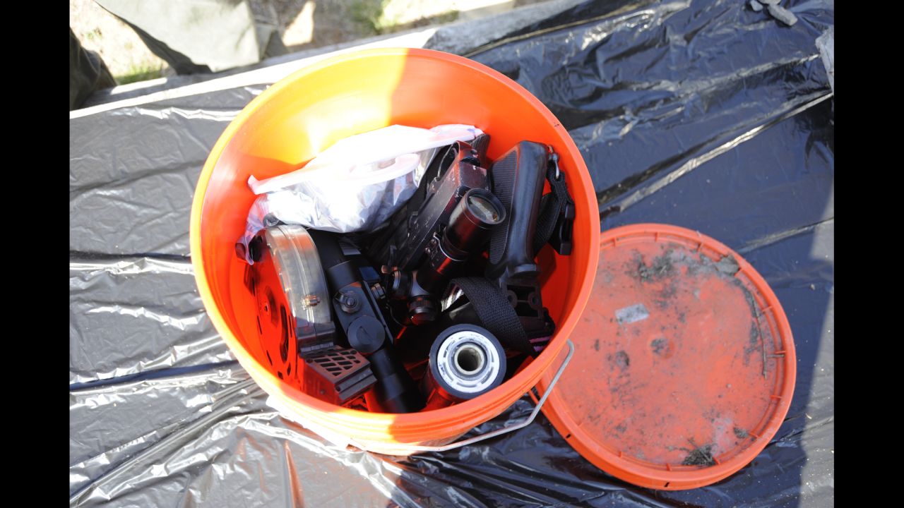 The cache included a a .22-caliber Ruger weapon without a stock, empty magazines, ammunition, and a silencer.
