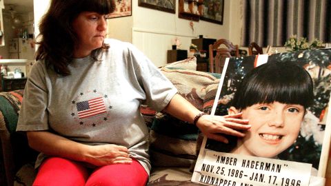 Donna Norris touches a photograph of her daughter, Amber Hagerman, at her Hurst, Texas, home. The 9-year-old's body was found a few days after she'd been kidnapped. A public alert system was named for the Arlington girl.  