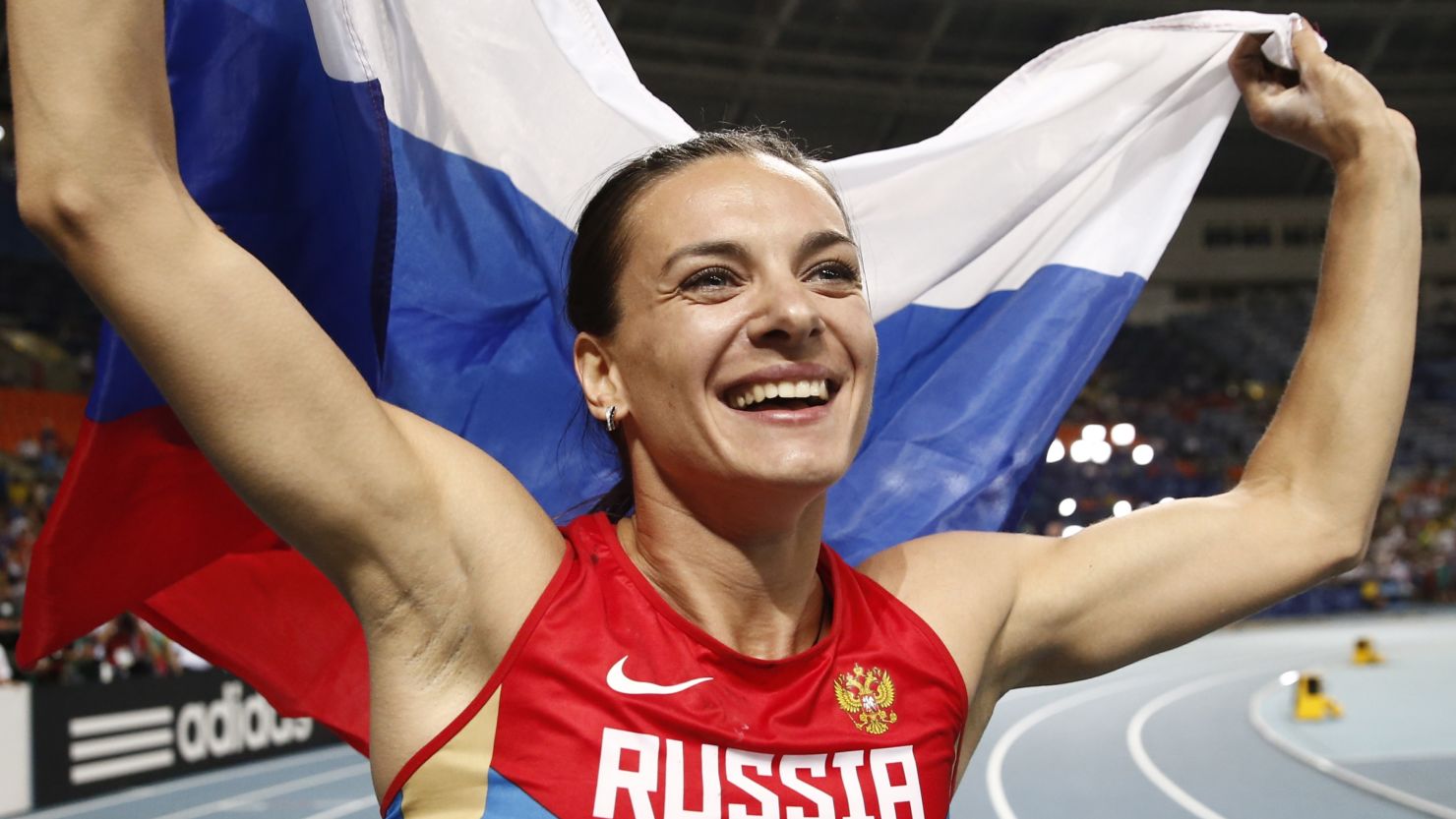 Golden girl: Yelena Isinbayeva celebrates her victory in the World Championship pole vault in Moscow.