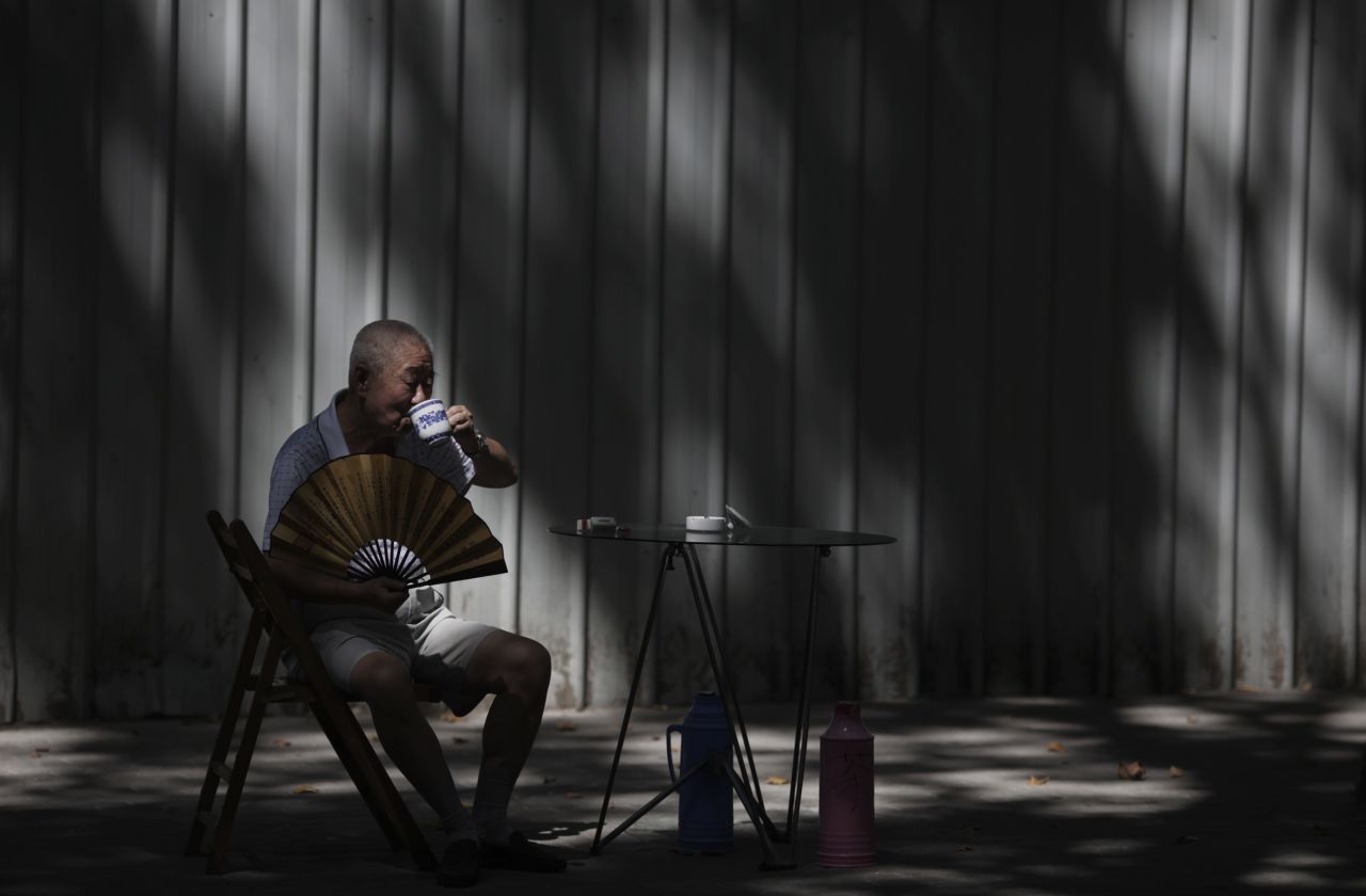 A man sips tea while sitting in the shade to cool off at a park in Shanghai, China, on August 12. <a href="http://www.cnn.com/2013/08/08/world/gallery/week-in-weather/index.html">View last week's best weather photos.</a>