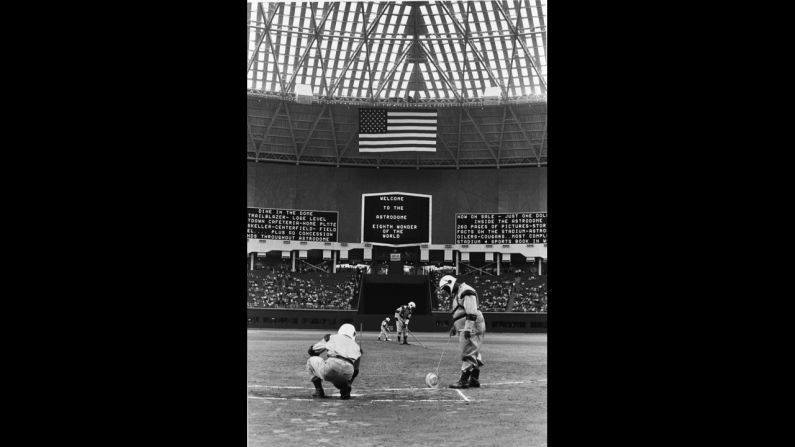 Groundskeepers wear spacesuit uniforms as they prepare for the Astrodome's first baseball game on April 12, 1965. The structure, with an inside height of 208 feet, has sat mostly empty since the Houston Astros left for a more modern stadium in 1999.