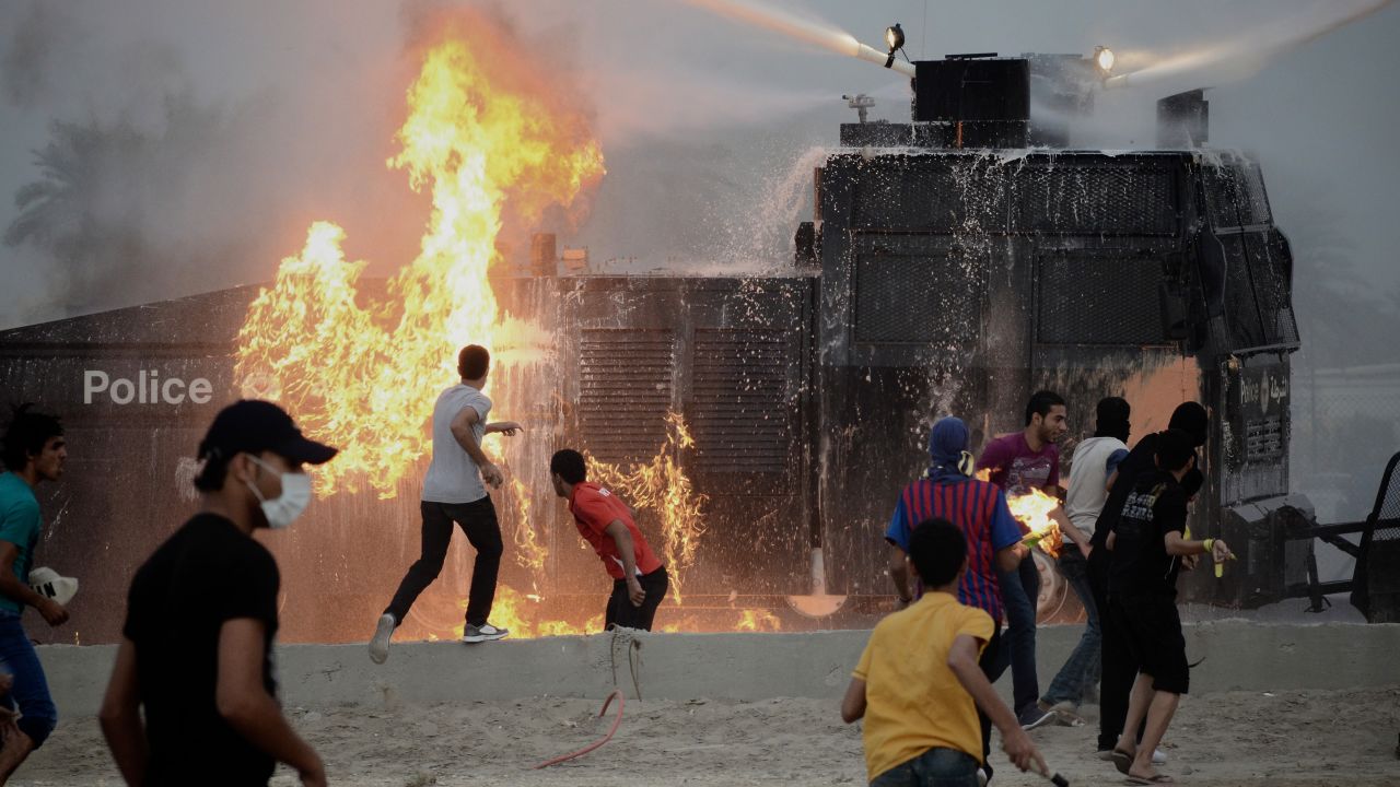 Bahraini demonstrators throw Molotov cocktails at a police water cannon vehicle west of Manama on April 6, 2012. 