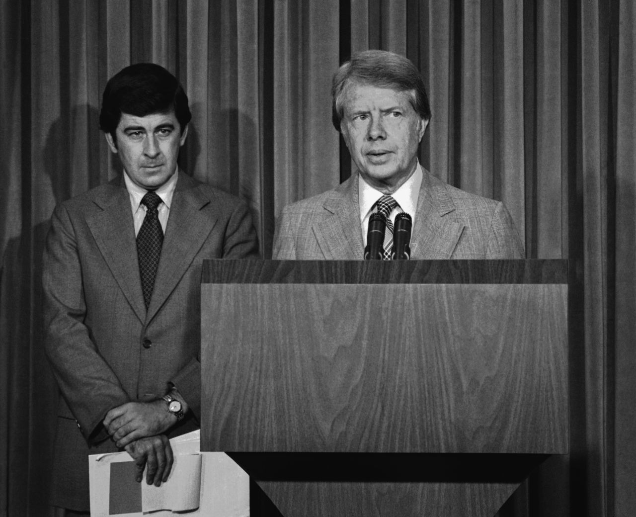 President Jimmy Carter, with his special assistant for health issues, Dr. Peter Bourne, beside him, talks to reporters at the White House about his drug abuse control message to Congress on August 2, 1977. Among other things, he called for the elimination of all federal criminal penalties for the possession of up to one ounce of marijuana.