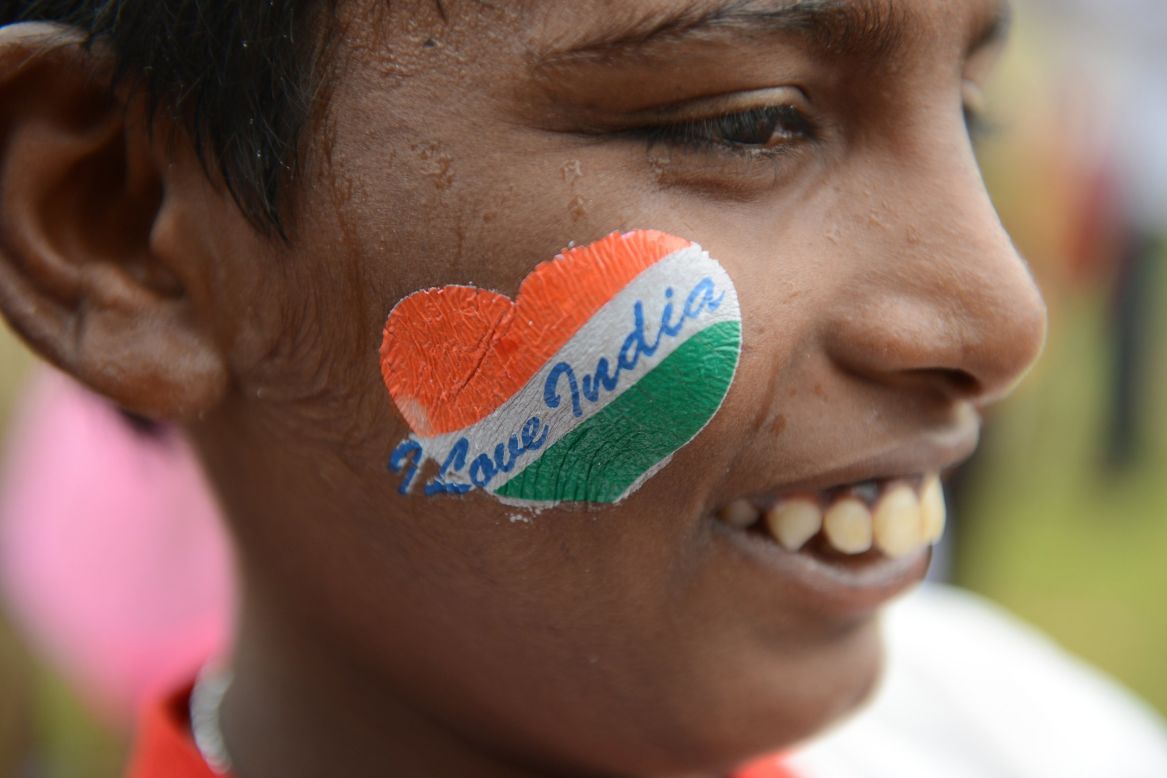 A pupil, cheek decorated with a patriotic message, participates in celebrations in Secunderabad, the twin city of Hyderabad. 