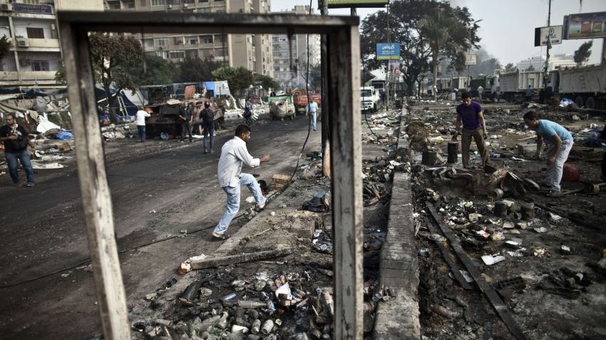 People search through the debris at Rabaa al-Adawiya square in Cairo on Thursday, August 15, following a crackdown on the protest camps of supporters of Egypt's ousted president Mohamed Morsy yesterday.
