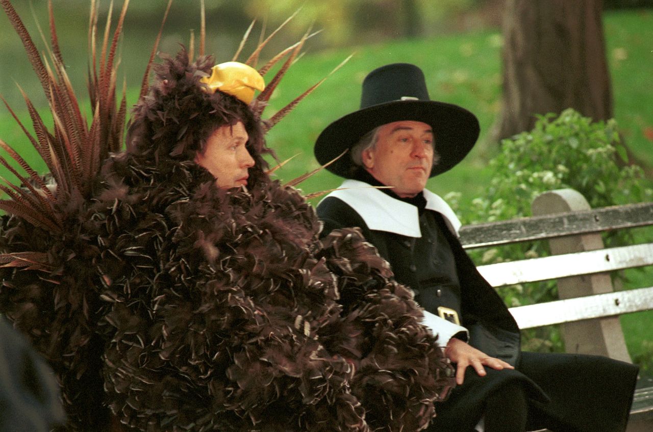 Billy Crystal, left, dressed as a turkey, sits on a bench with De Niro, dressed as a pilgrim, during the filming of a Thanksgiving-themed "I Love New York" commercial in 2001.