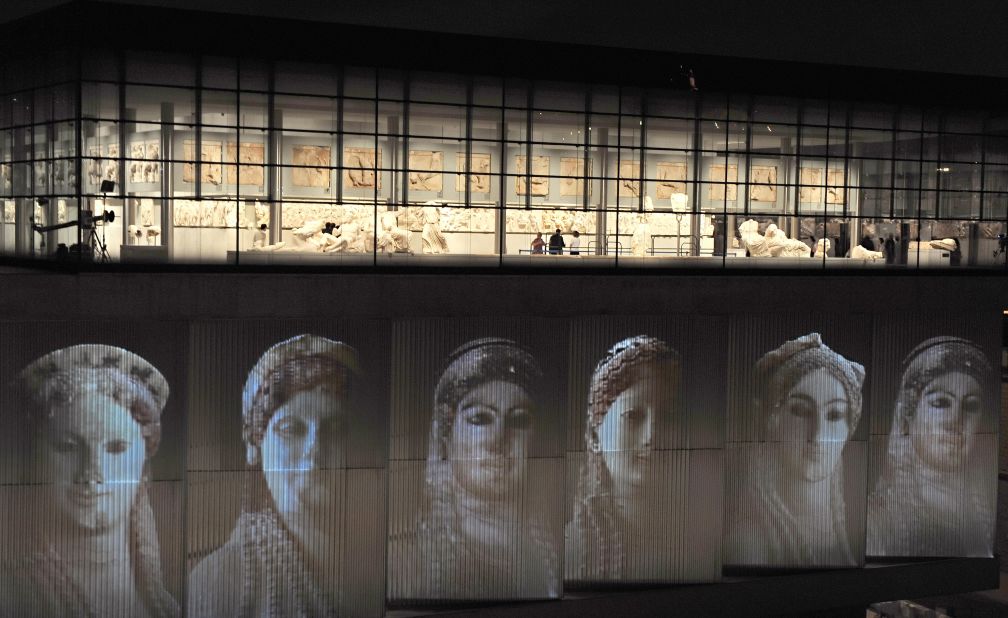 The genius of Ancient Greek classicism is nowhere better expressed than in the Parthenon sculptures in the Acropolis Museum. Here female sculptures are projected on the Athens building. 