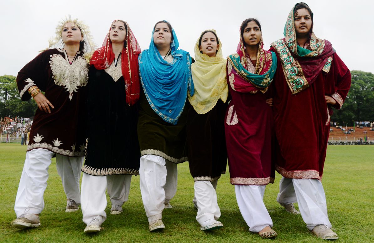 Kashmiri women dance during an event at The Bakshi Stadium in Srinagar.