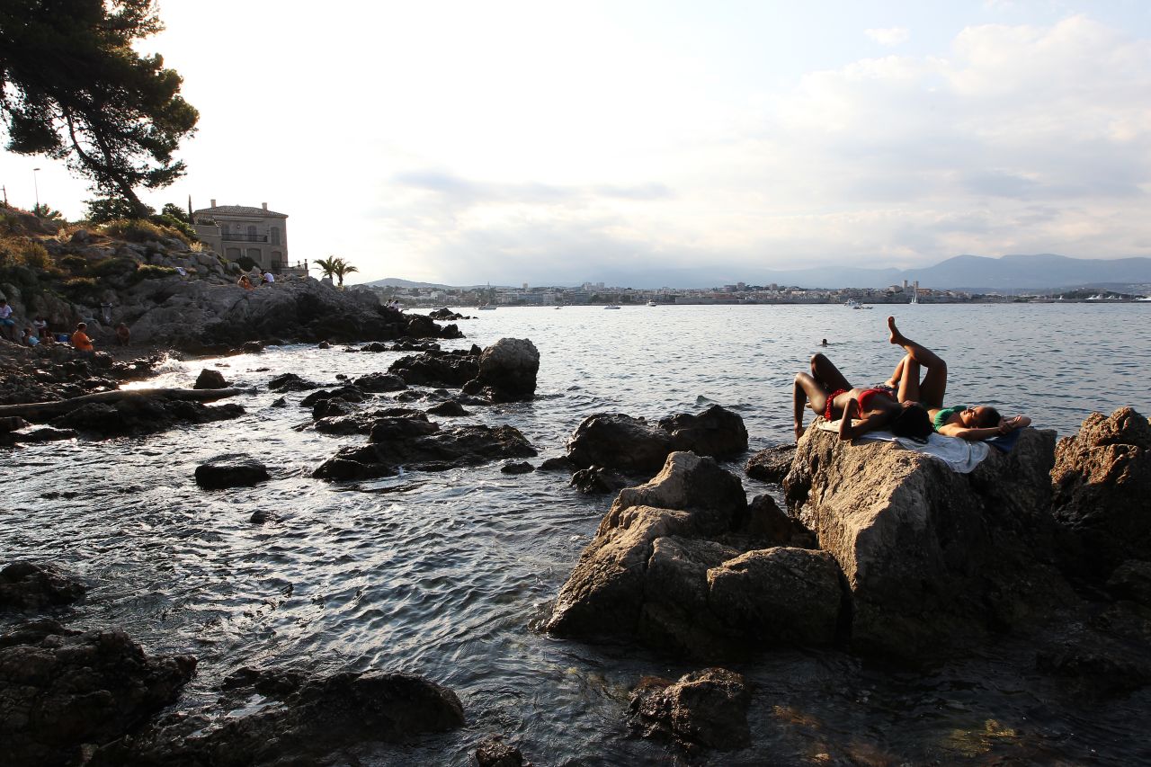 Women sunbathe in Antibes, France, on Thursday, August 15. 