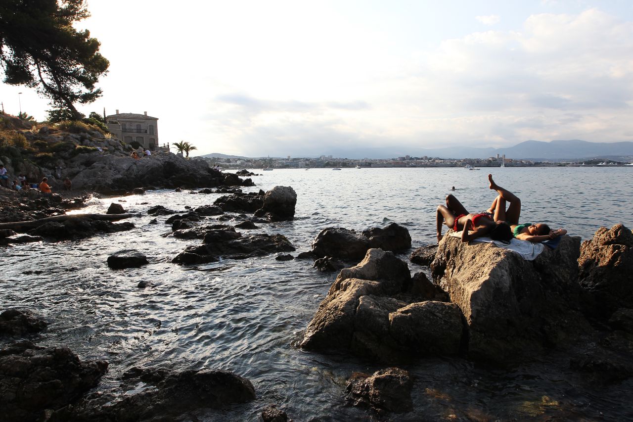 Women sunbathe in Antibes, France, on Thursday, August 15.
