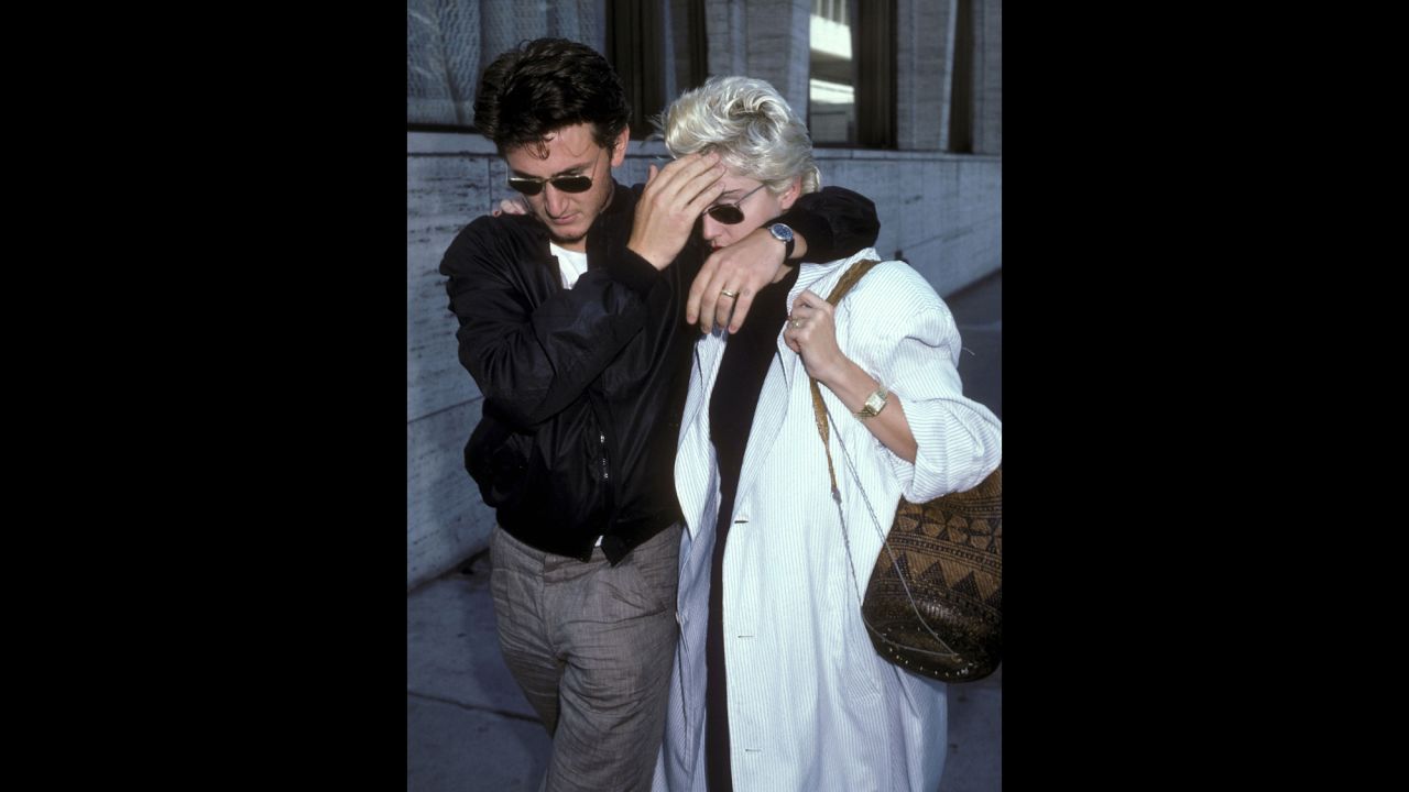 Then-husband Sean Penn shields Madonna from the paparazzi during a lunch break in New York on August 13, 1986.