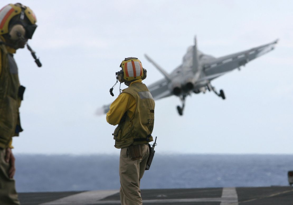 Jets take off from the deck of the USS Nimitz.