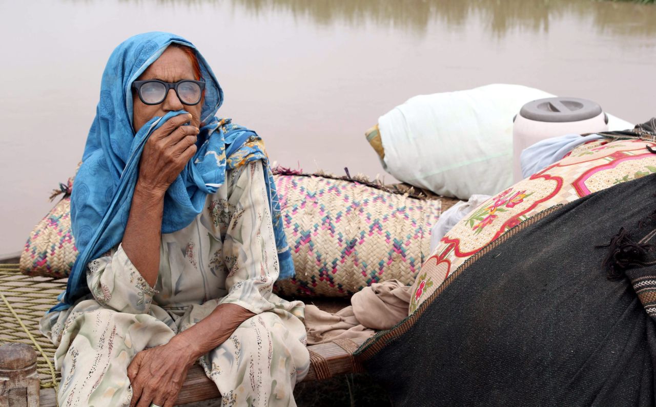 A woman affected by flooding waits for relief near Multan, Pakistan, on August 16.