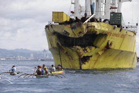 Volunteers search for victims near the damaged cargo ship Sulpicio Express Siete on Saturday, August 17, a day after it collided with a passenger ferry  in Talisay, in the Cebu province of the Philippines. The ferry, which sank, is thought to have been carrying about 700 passengers.