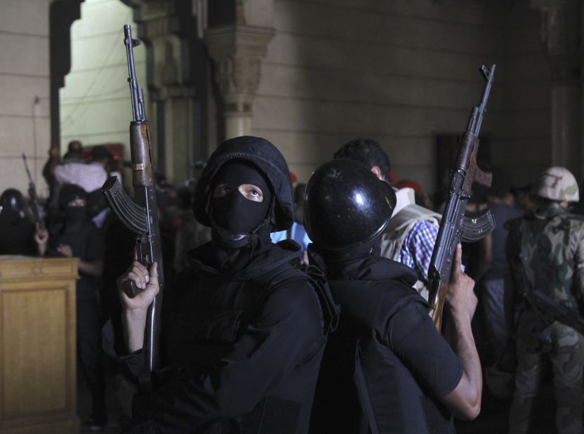 Policemen stand guard inside a room of Al-Fateh mosque as supporters of ousted president Mohamed Morsy exchange gunfire with security forces inside the mosque in Cairo on Saturday, August 17, 2013. 
