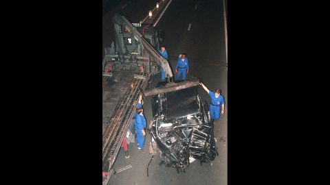 The wreckage of the car is prepared to be moved after the crash. 