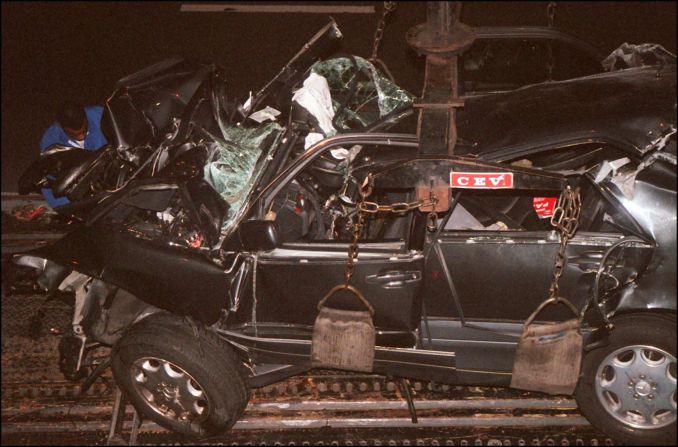 A French police expert can be seen in the background working on the wreckage in the tunnel where they crashed.