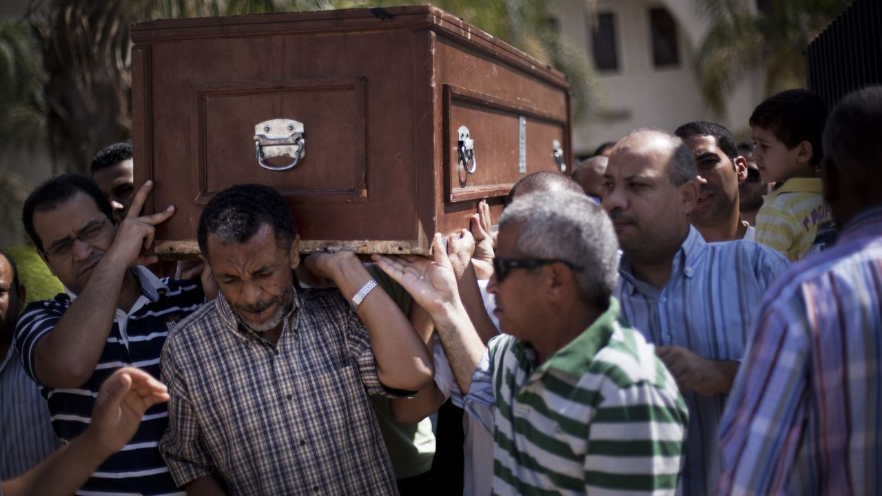 Friends and relatives of Ammar Badie, 38, killed during clashes in Ramses Square, carry his coffin during his funeral in Al-Hamed mosque in Cairo on August 18, 2013. Ammar Badie was the son of the Muslim Brotherhood's spiritual leader, Mohammed Badie.