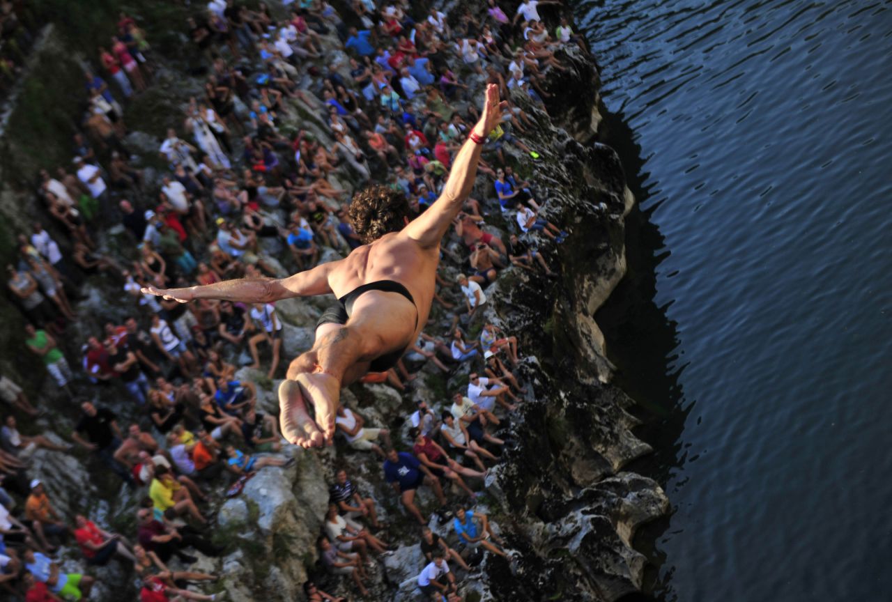 A diver jumps off a bridge into the Soca River on Sunday, August 18, during a traditional jumping competition in Kanal ob Soci, Slovenia.