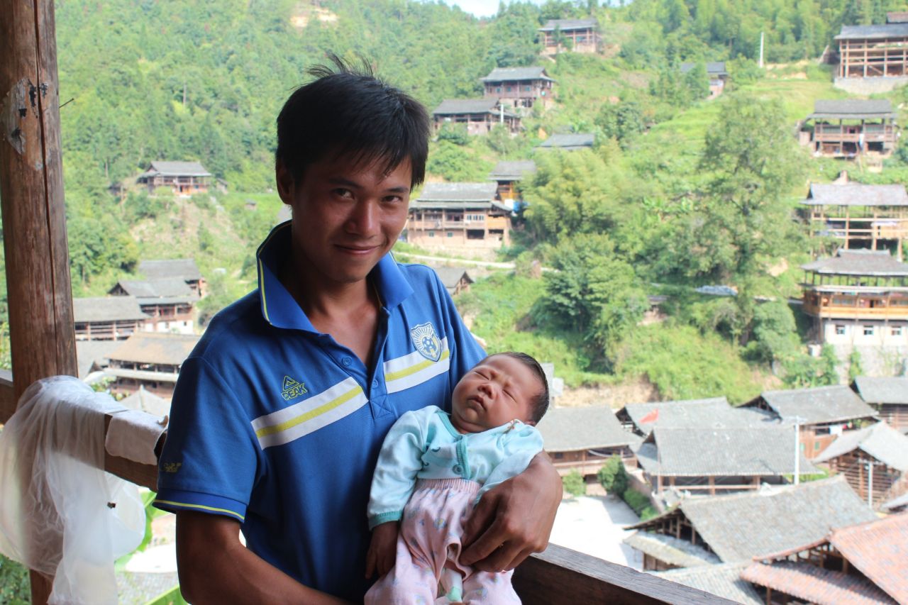 Like many young men in the village, Shi Tao is a migrant worker. He has returned home from the southern factory town of Dongguan for the birth of his first child but will soon leave again.