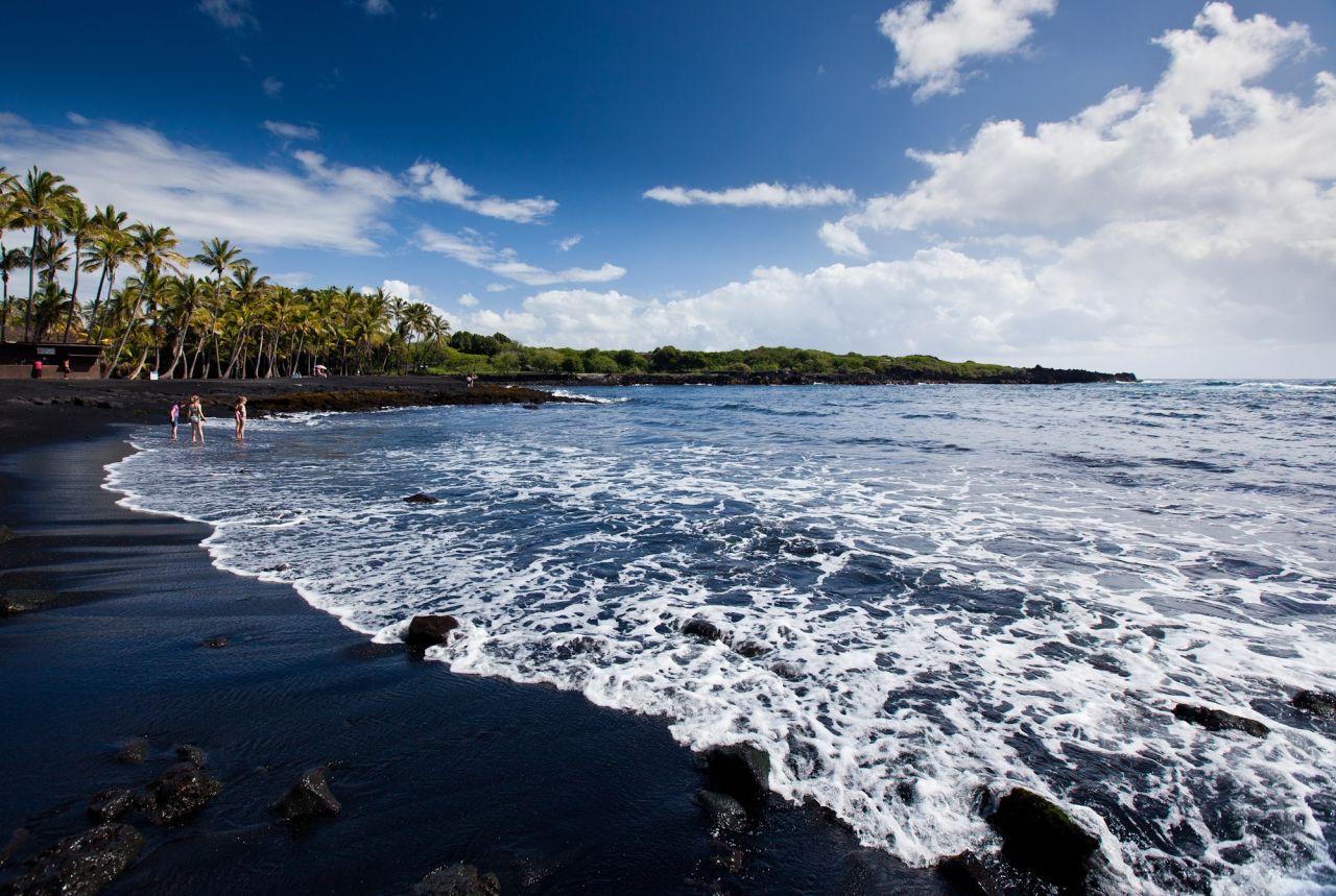 Located south of Hawaii Volcanoes National Park, Punaluu Black Sand Beach gets its color from volcanic activity and is also known for sea turtle sightings.