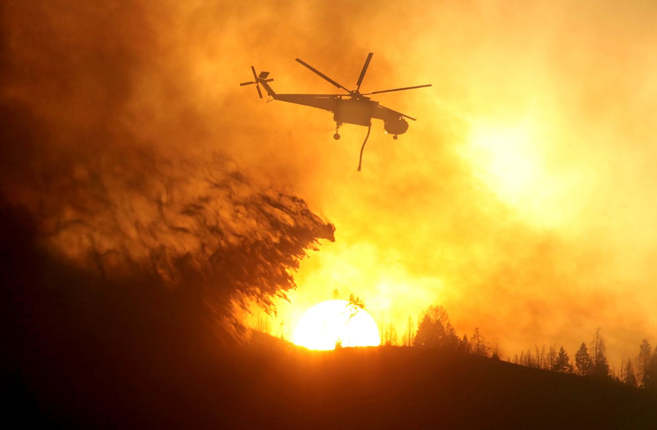 A helicopter makes a drop while battling the Beaver Creek Fire on August 17.