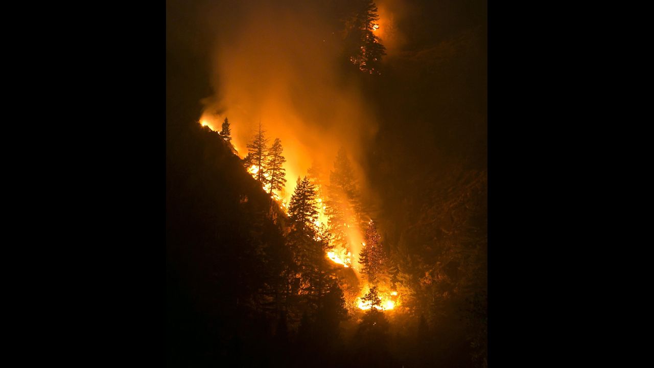 Fire creeps down the western canyon wall above the Wood River in Hailey, Idaho, on August 17.
