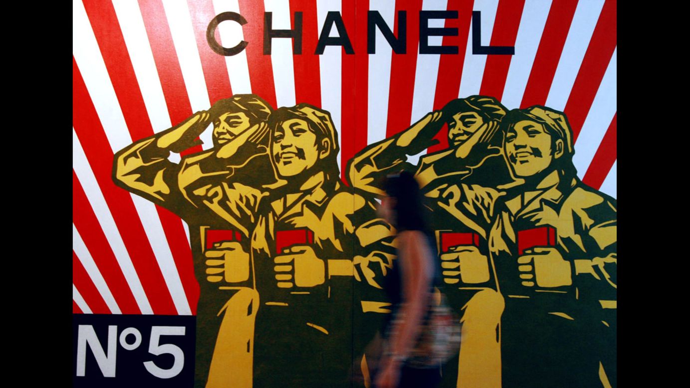 A woman walks past a Chanel-inspired piece by political pop artist Wang Guangyi in the Hamburger Kunsthalle art gallery in Hamburg, Germany.
