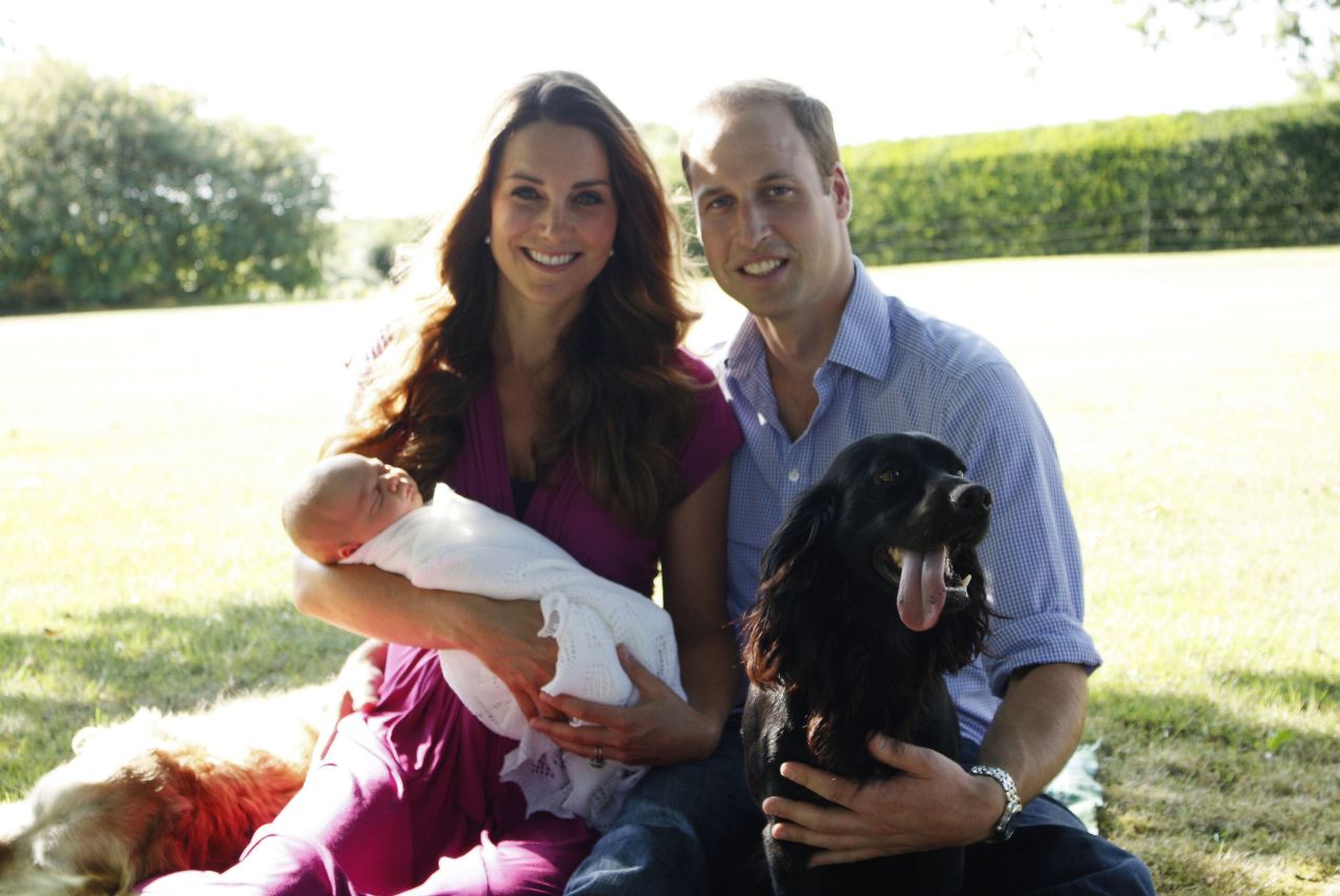 In August, Catherine and William pose with George and their dogs Lupo, right, and Tilly in the garden of Catherine's family home in Bucklebury, England.