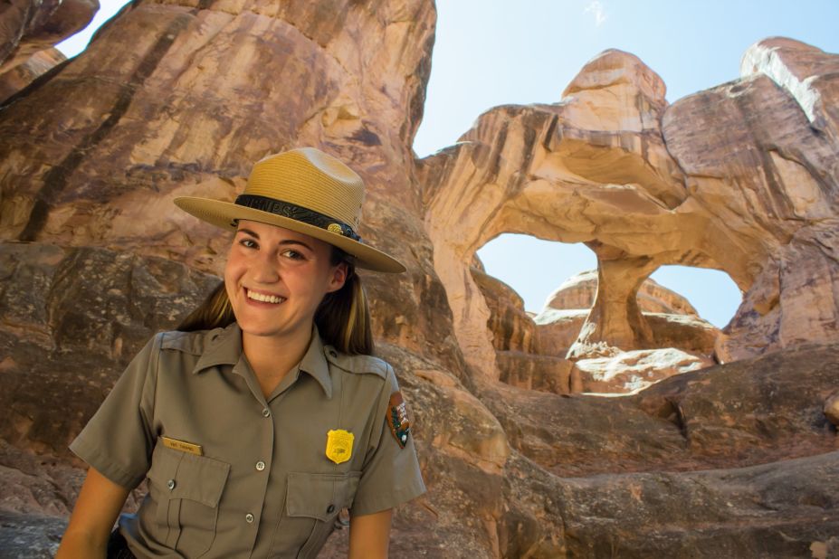 Kait Thomas, interpretative ranger at Arches National Park, stands in the Fiery Furnace below Twin Arches.