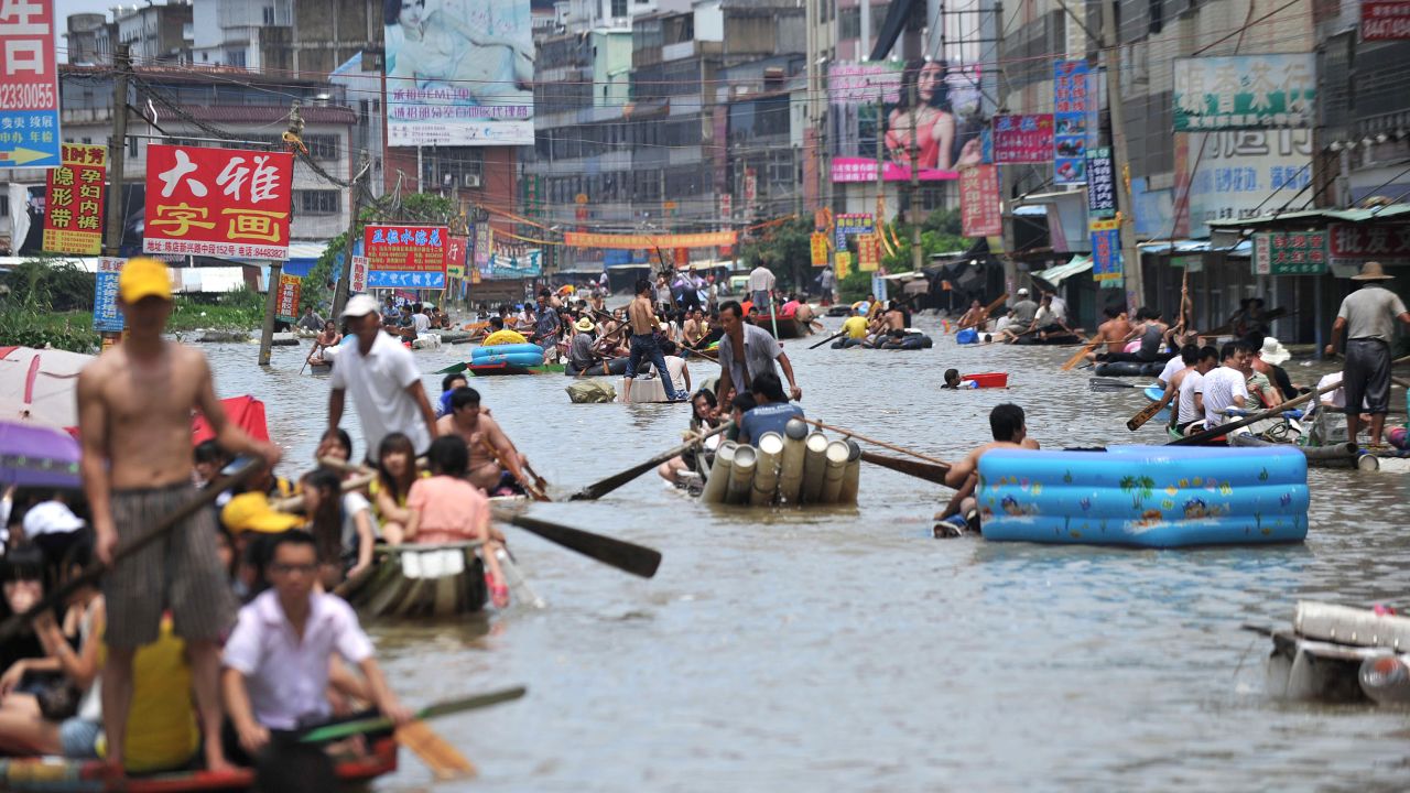 People travel on boats and makeshift rafts down a flooded street in Shantou, China, on August 19.