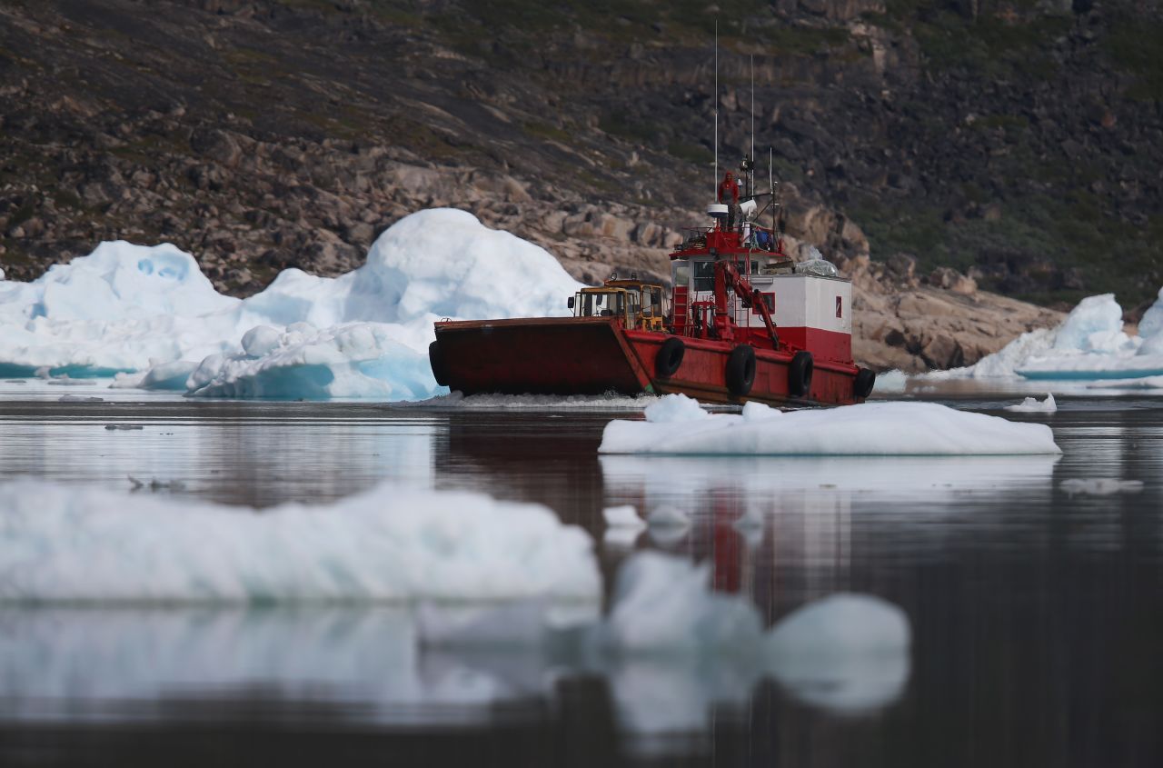 A boat navigates among calved icebergs from the nearby Twin Glacier on July 31 near Qaqortoq. Boats are a crucial mode of transportation in a country that has few roads. 